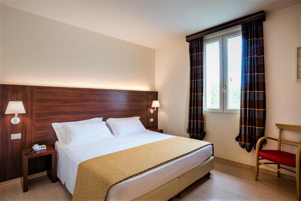 Postel nebo postele na pokoji v ubytování Delfina Palace Hotel