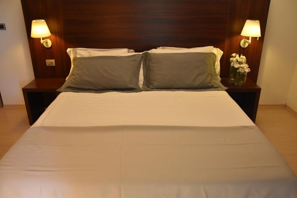 Postel nebo postele na pokoji v ubytování Delfina Palace Hotel