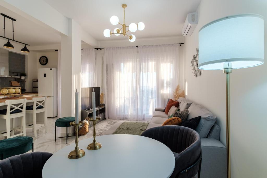 a living room with a couch and a table at Home is in Thessaloniki