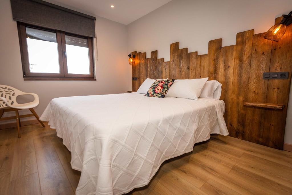 Łóżko lub łóżka w pokoju w obiekcie Apartamentos Casa Carin