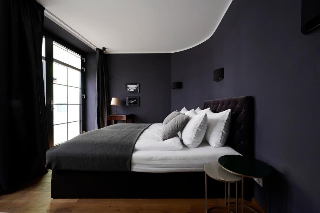 1 dormitorio con cama grande y ventana grande en numa I Nora Apartments, en Salzburgo