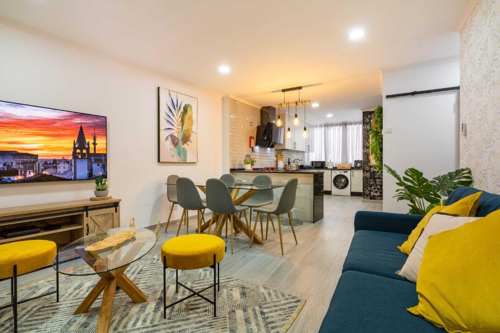 a living room with a blue couch and a table at HOME@abrantes in Abrantes