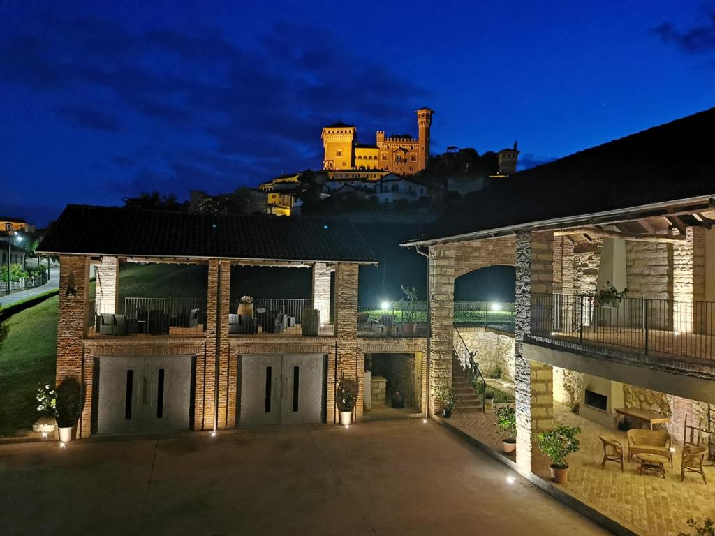 a large house with a castle in the background at Agriturismo Airale in Cereseto