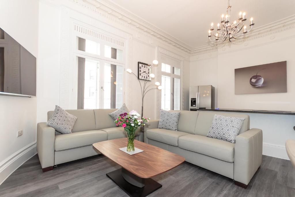 a living room with a couch and a table at The Windsor Suite in Plymouth