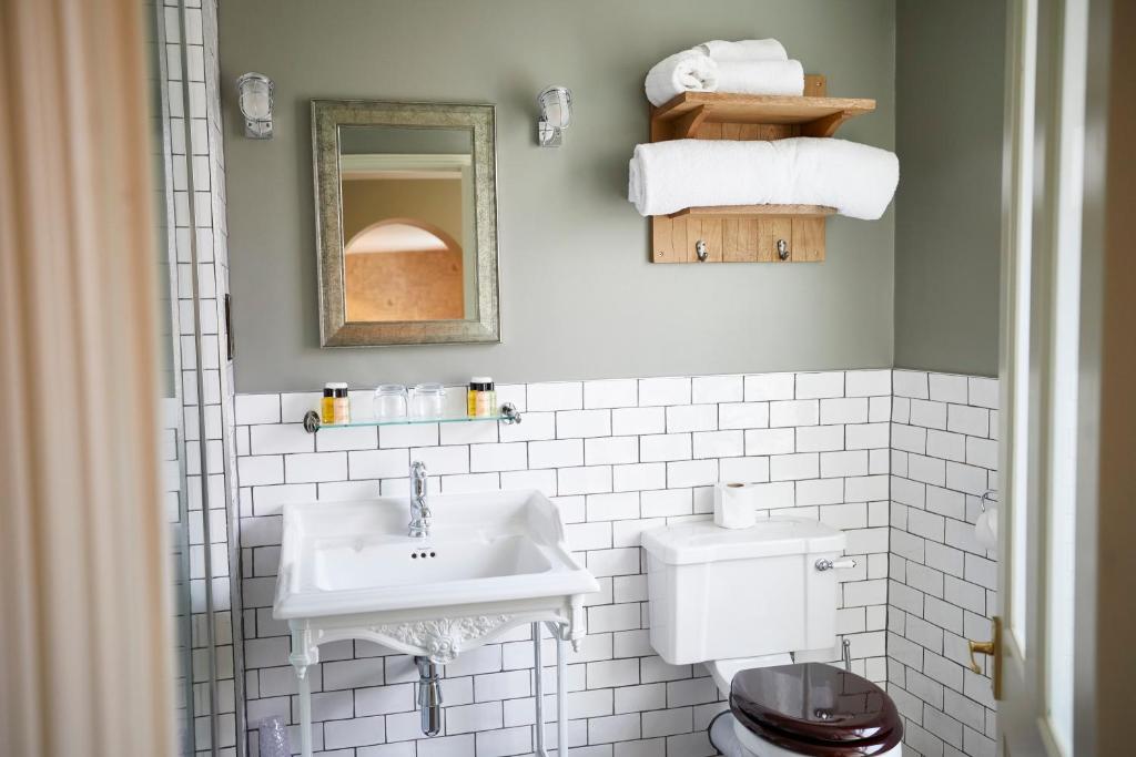 a bathroom with a sink and a toilet at Wykeham Arms in Winchester