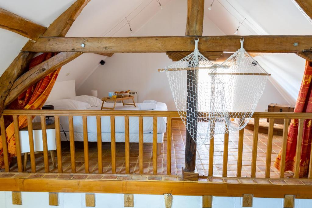 a room with a hammock in a attic at Le Domaine des Eléphants - SPA EN OPTION - 900m du Zoo in La Cévrie
