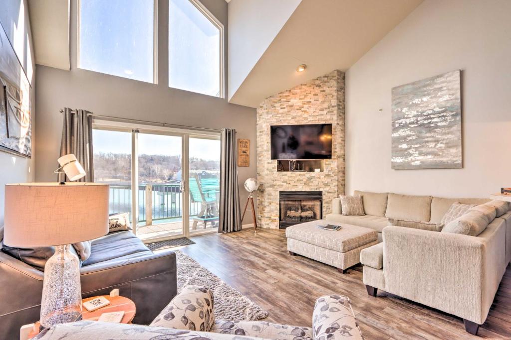 a living room with a couch and a fireplace at Scenic Family Condo with Game Room and Boat Dock! in Camdenton
