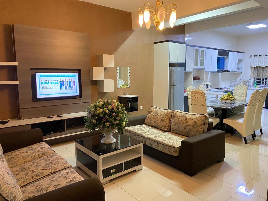 ein Wohnzimmer mit einem Sofa und einem Esszimmer in der Unterkunft Azzalea Homes 5 @ Golden Hills Cameron Highlands in Brinchang