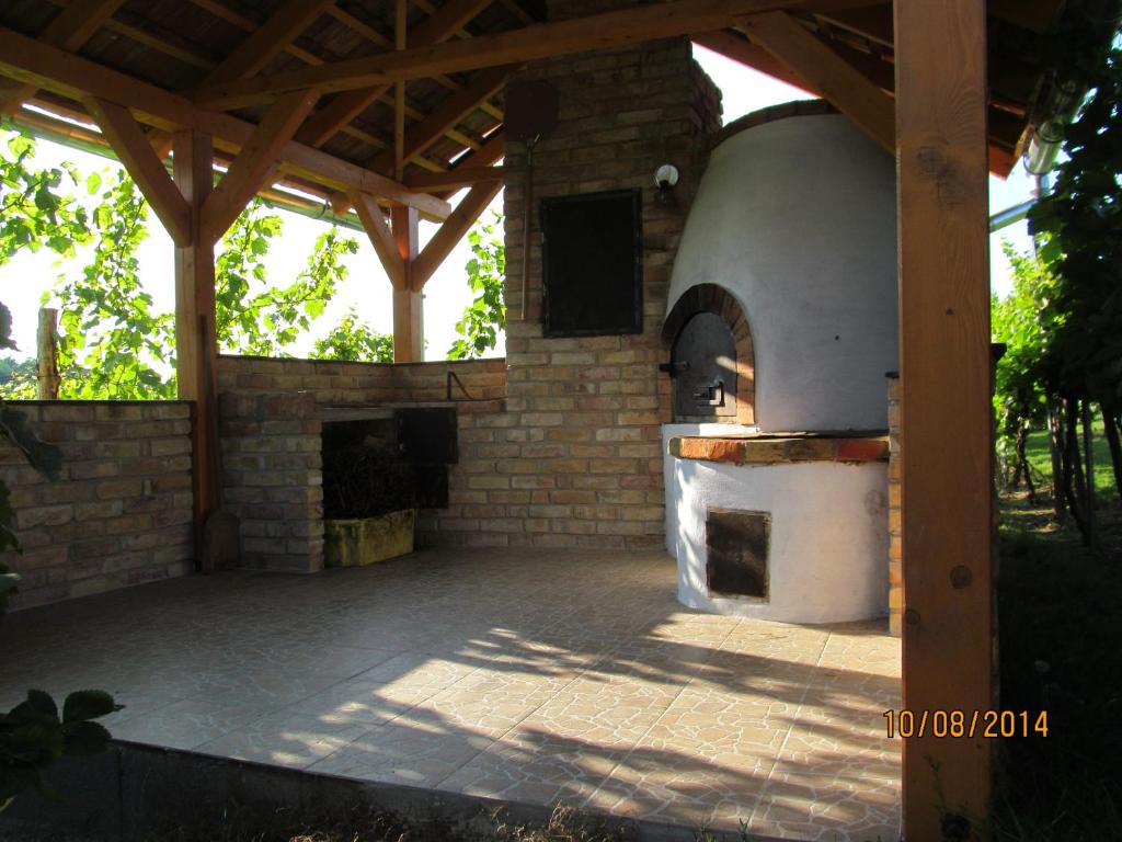 an outdoor kitchen with an oven in a patio at Balatonlelle-Kishegy in Balatonlelle