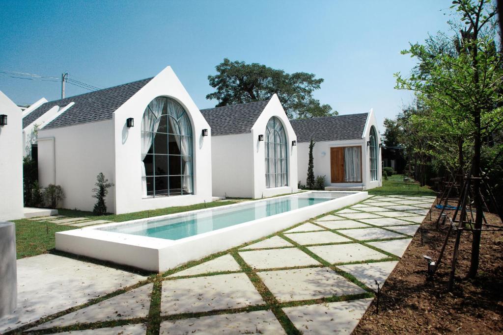 a house with a swimming pool in the yard at La Kana Boutique Villa in Kamphaeng Phet