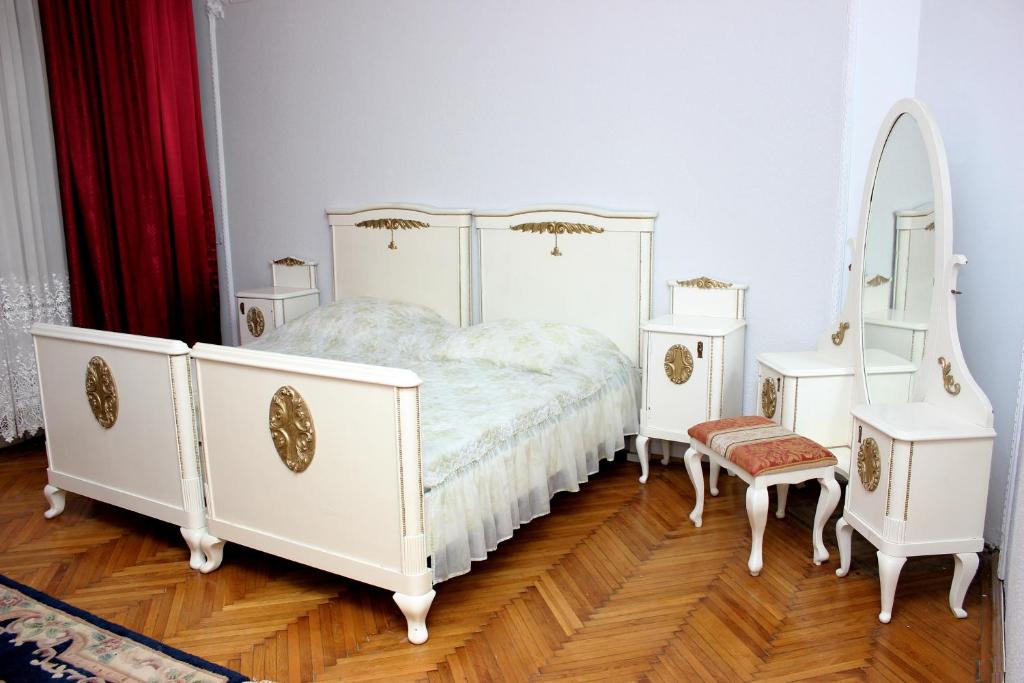 a white bedroom with a bed and a mirror at Mosaico Alfetta Hostel in Timişoara