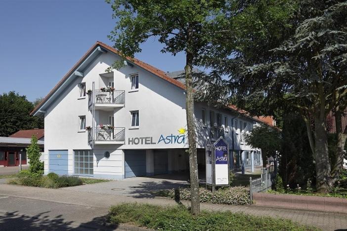 a hotel with a sign on the side of a building at Hotel Astra Rastatt in Rastatt