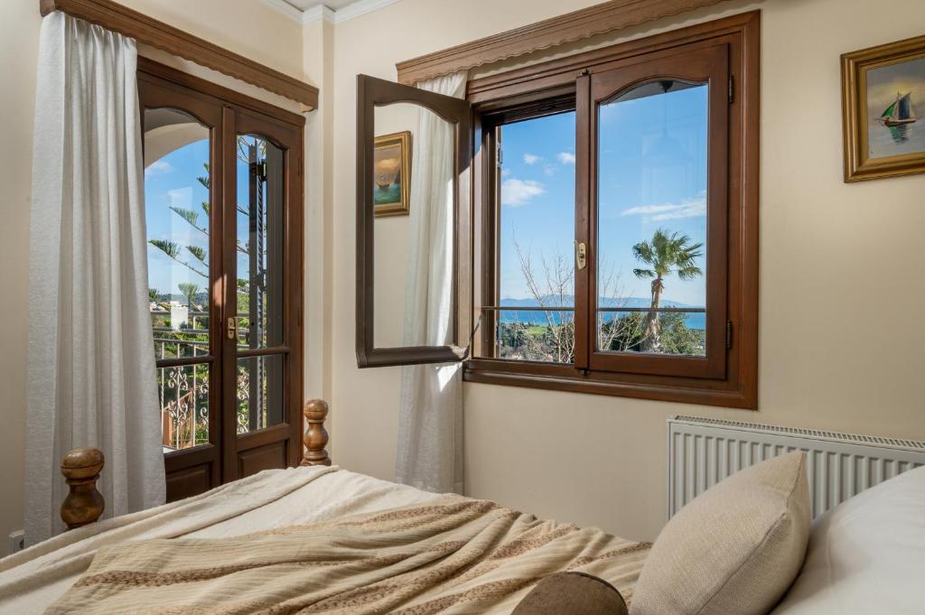 um quarto com uma cama e vista para o oceano em Vivian's Residence Endless View em Svoronata