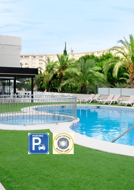 a swimming pool with a sign in front of it at Prince Park in Benidorm