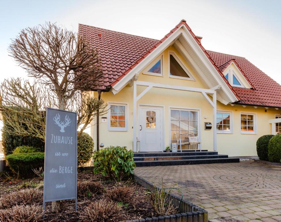 a house with a sign in front of it at Zuhause auf Zeit in Osterode