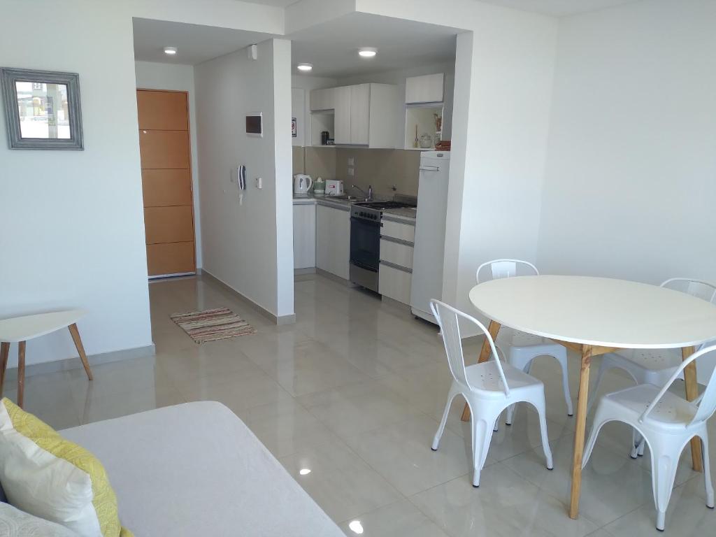 a kitchen and dining room with a table and chairs at Departamento Marea III Puerto Madryn in Puerto Madryn