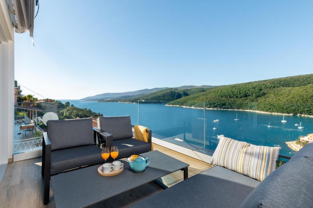 a balcony with a view of the water at D&A Superior Apartman in Rabac