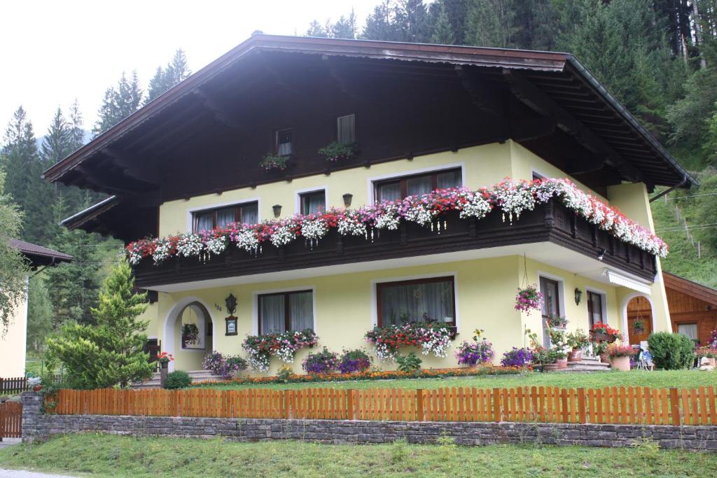 a house with flowers on the balcony at Schwarzenbacher in Lungötz