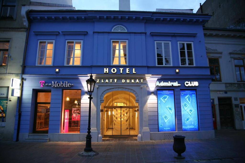 a blue building with a hotel with a large door at Hotel Zlaty Dukat in Košice