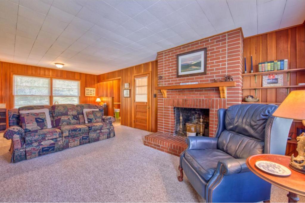 a living room with a couch and a fireplace at King House in Lake Junaluska