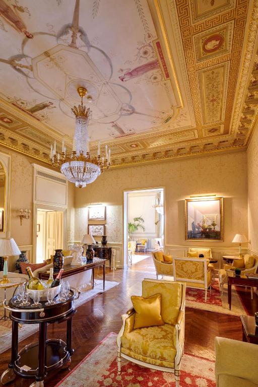 a living room with a ceiling with a chandelier at Shangri-La Paris in Paris
