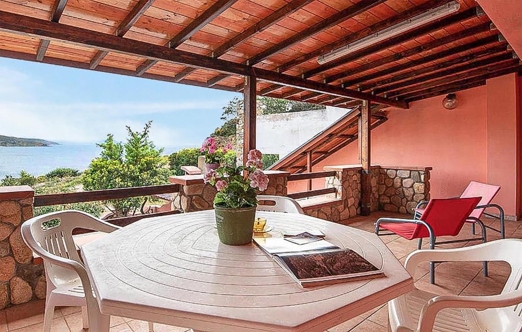 a wooden table and chairs on a patio at Amazing Home In Torre Dei Corsari With Kitchen in Torre Dei Corsari