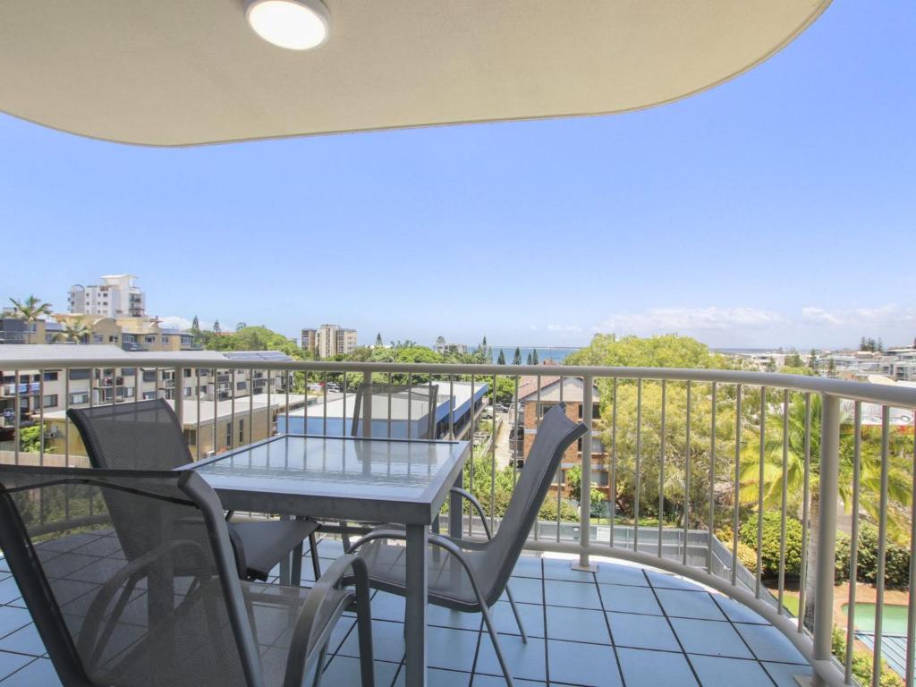 a patio with a table and chairs on a balcony at Cheltenham Apartments Unit 11 40 King St in Caloundra
