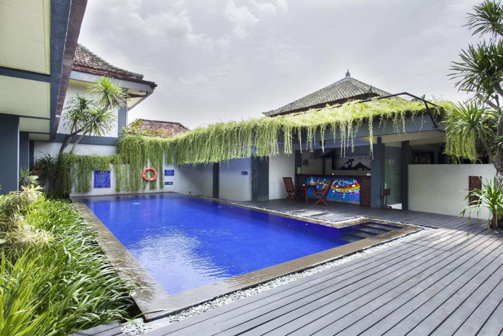 a swimming pool in the backyard of a house at The Yani Hotel Bali in Denpasar