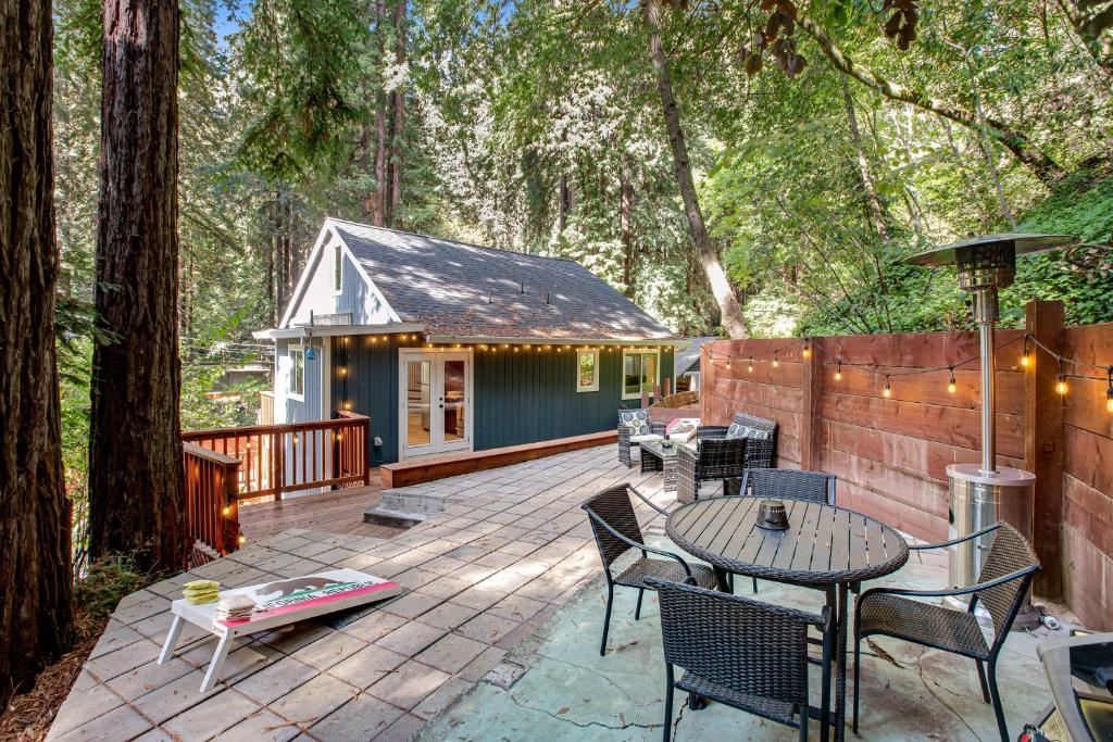a patio with a table and chairs and a house at Canyon House in Guerneville