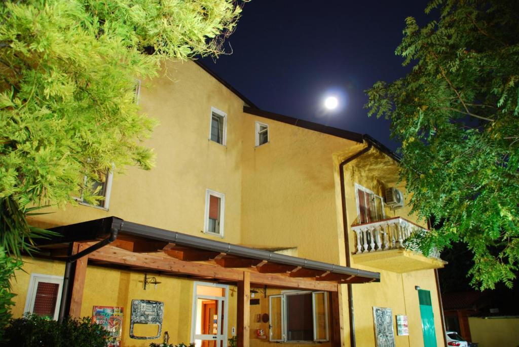 a large yellow building with a moon in the sky at Bed and Breakfast Pieffe in Frascineto
