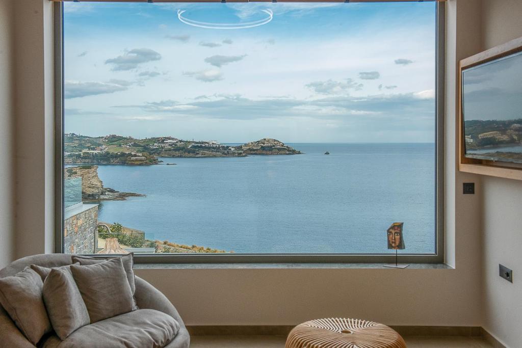 a view of the ocean from a large window at Ligaria Mare in Agia Pelagia