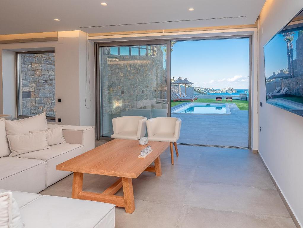 a living room with a couch and a table at Ligaria Mare in Agia Pelagia
