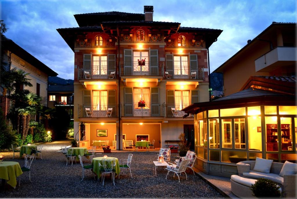 a large building with tables and chairs in front of it at Residence Ortensia in Baveno