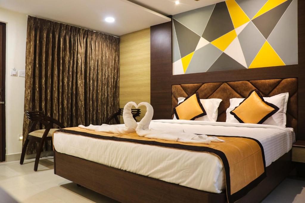 a bedroom with a bed with swans on it at Honey Hive in Port Blair