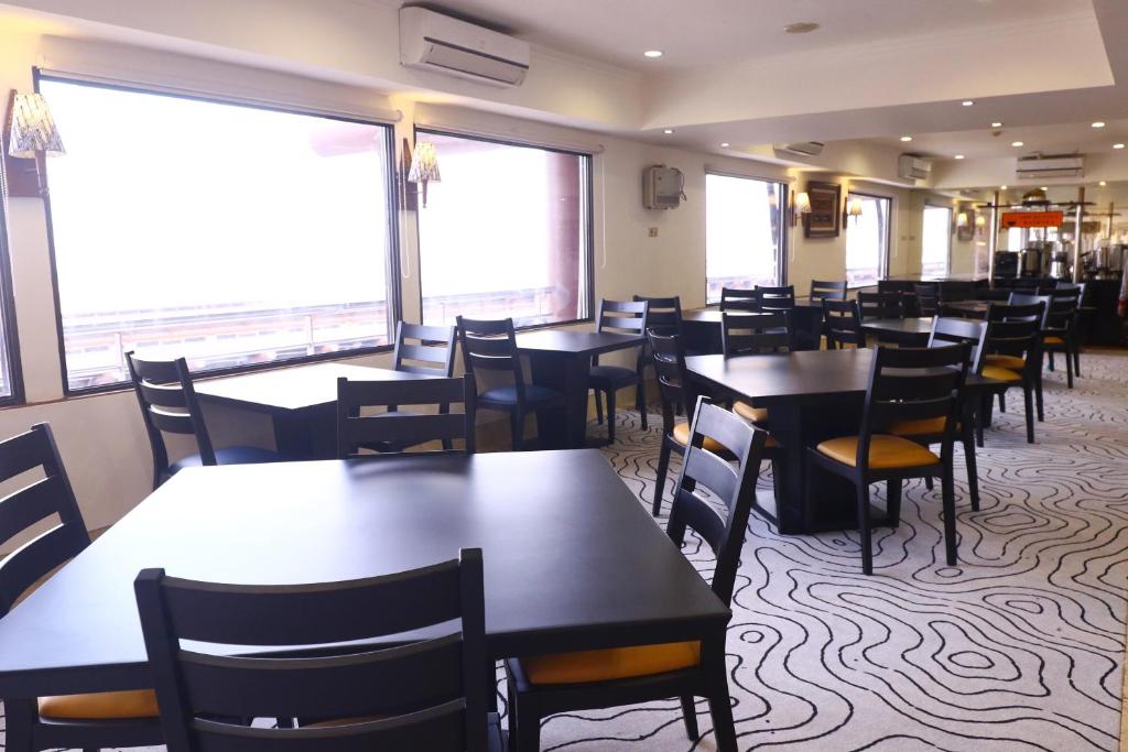 a dining room filled with tables and chairs at Jakarta Airport Hotel in Tangerang