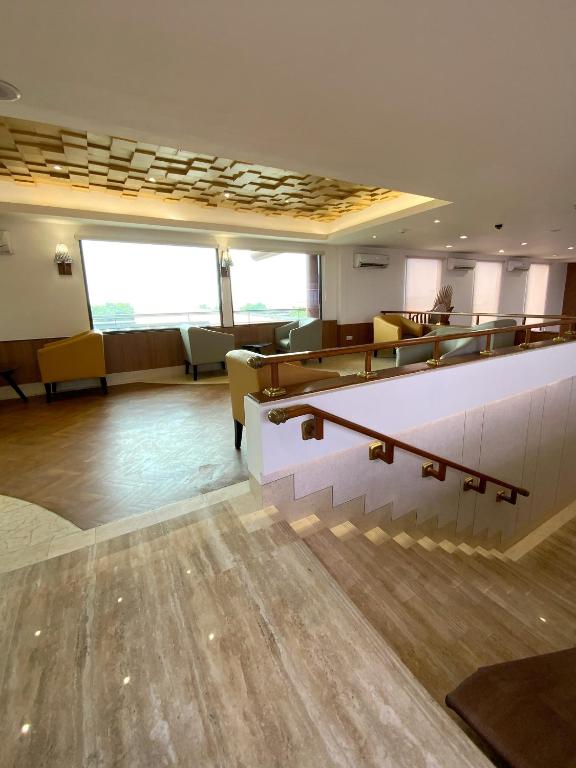 a waiting room with desks and chairs in a building at Jakarta Airport Hotel in Tangerang