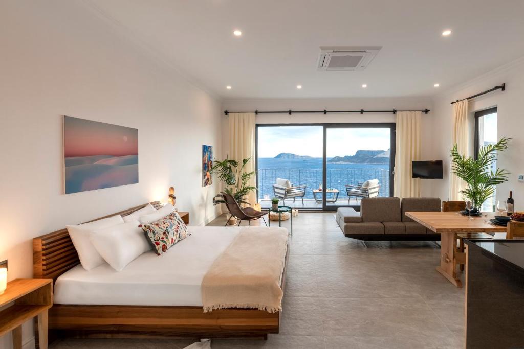 a hotel room with a bed and a living room at Born in Blue in Kaş