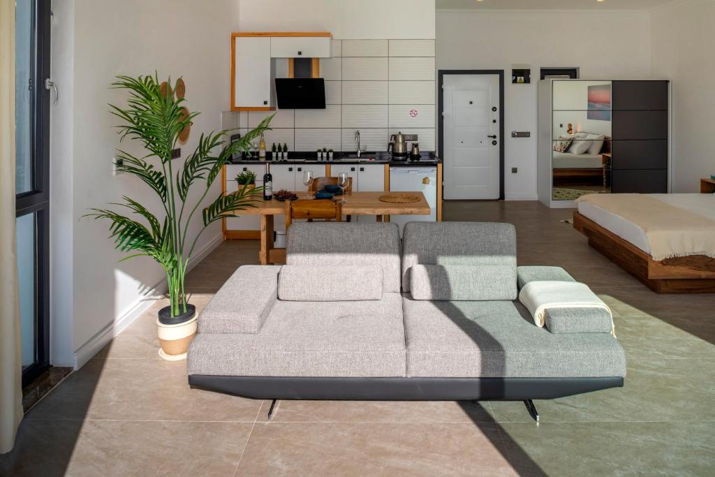 a living room with a couch and a bed at Born in Blue in Kaş