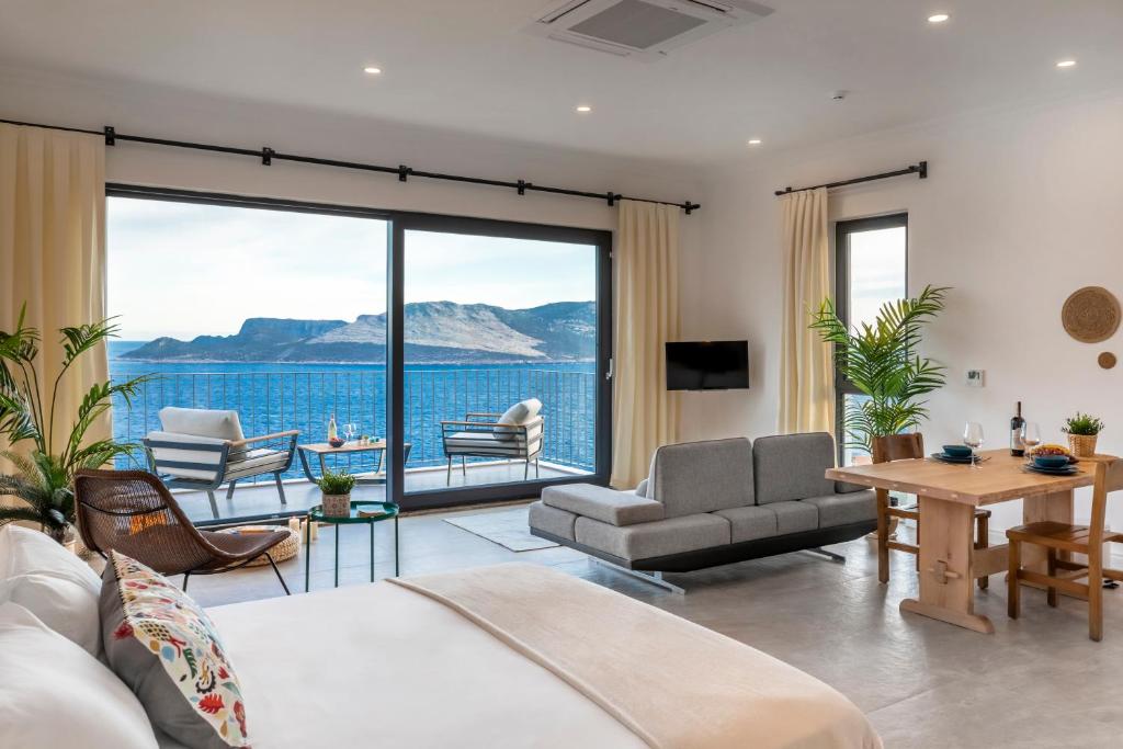 a living room with a view of the water at Born in Blue in Kaş