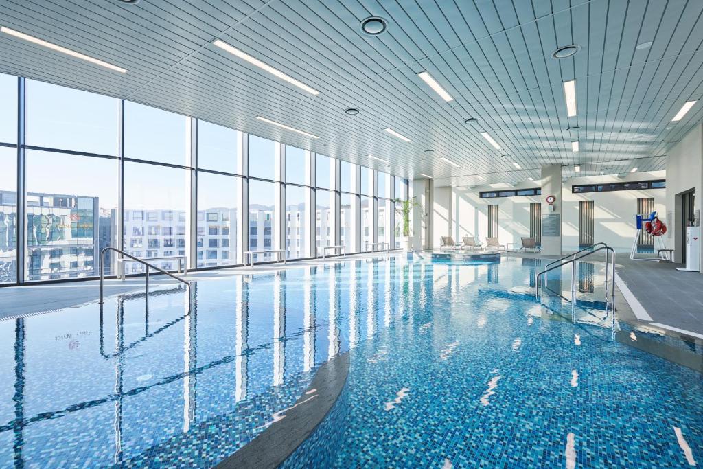 a swimming pool with a view of a building at Nine Tree by Parnas Seoul Pangyo in Seongnam