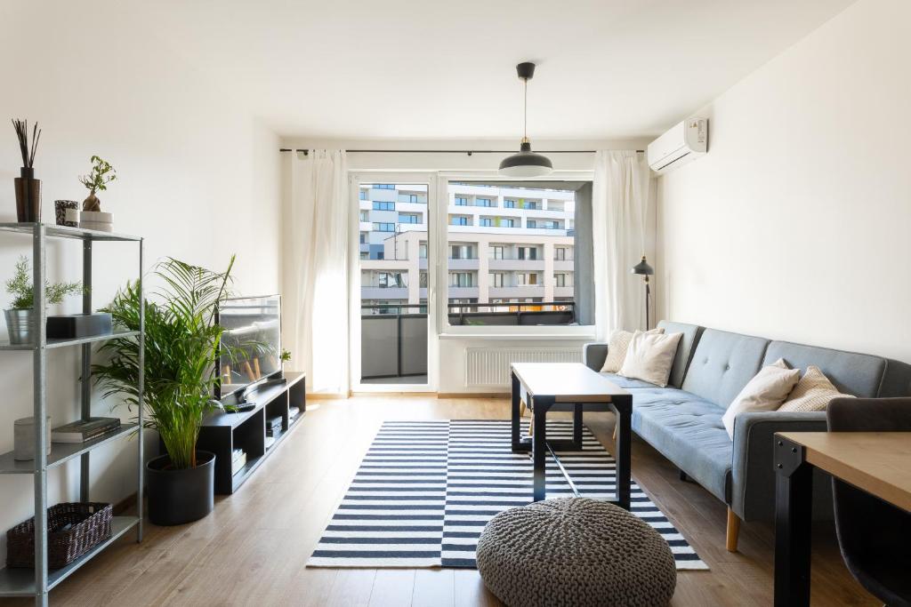 a living room with a couch and a table at Quiet & Cozy Apartment Old Town - free underground parking in Košice