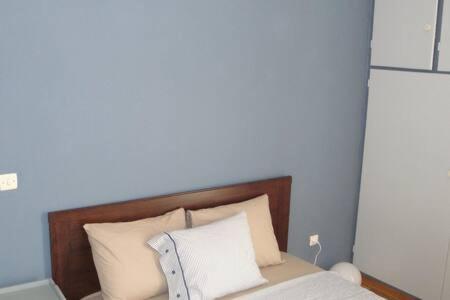 Łóżko lub łóżka w pokoju w obiekcie Illisia Roof Apartment