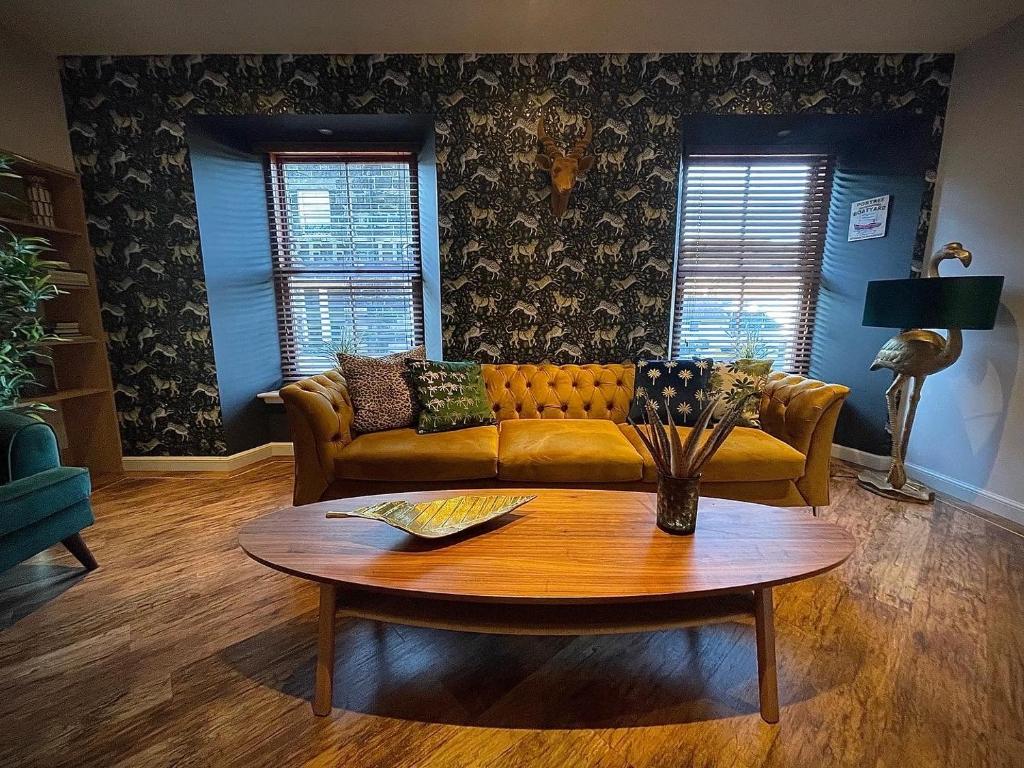 a living room with a couch and a table at Lower Flat, Nicolson House. in Portree