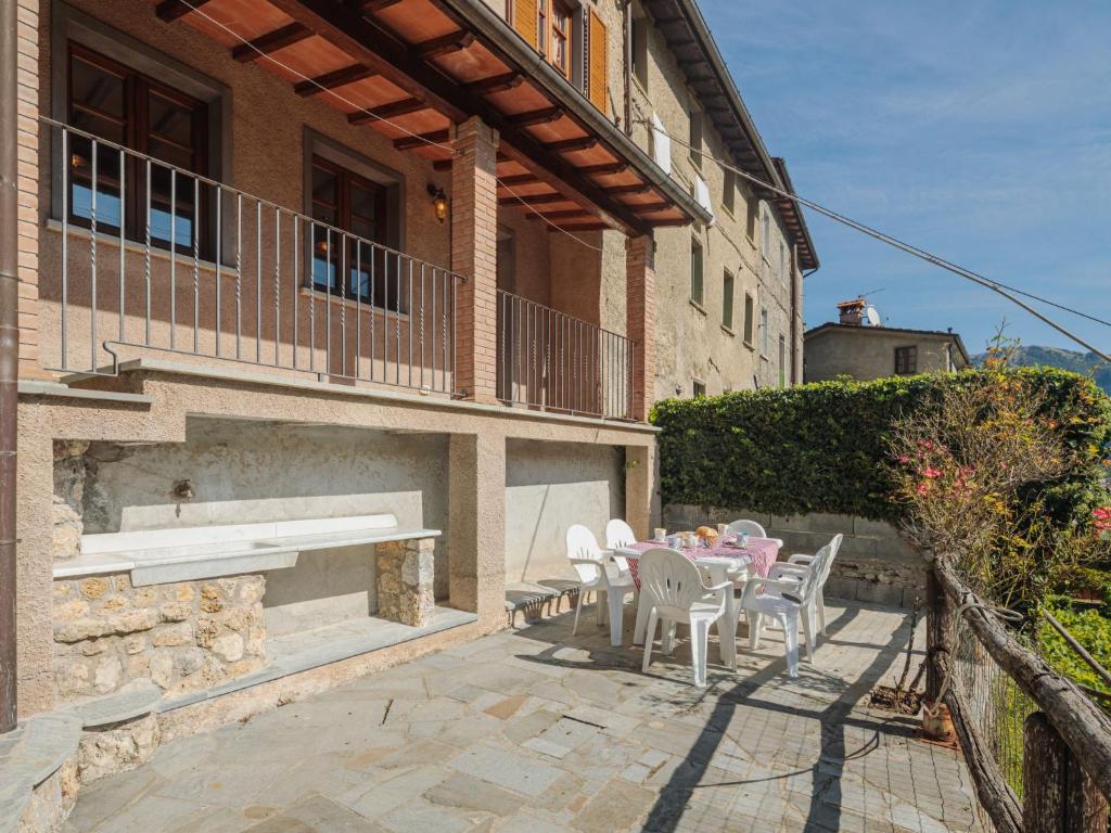 a patio with a table and chairs in front of a building at Holiday Home Da Franca by Interhome in Stazzema