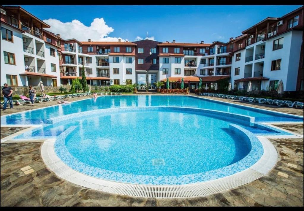a large swimming pool in front of some apartment buildings at private apartments in Apolon in Ravda