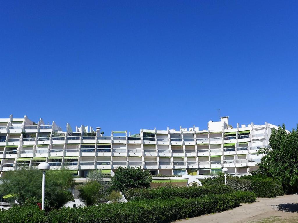 a large white building with trees in front of it at Apartment Arena-1 by Interhome in La Grande Motte