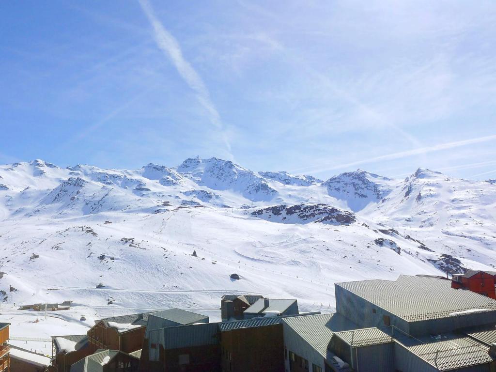 a view of a snowy mountain with a city and buildings at Apartment Arcelle-17 by Interhome in Val Thorens