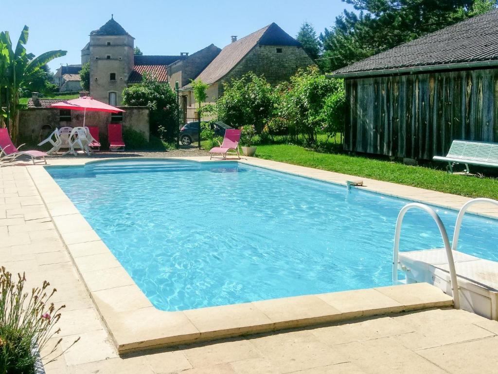 a swimming pool in the backyard of a house at Holiday Home Le Mas de Serre by Interhome in Nuzéjouls