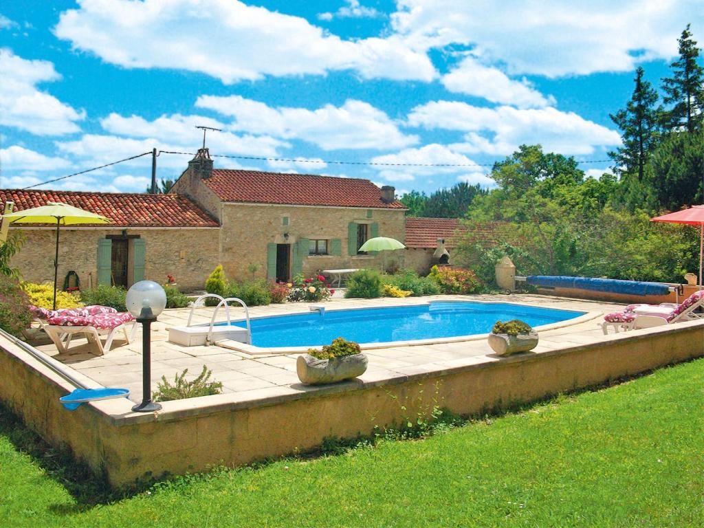 a swimming pool in the yard of a house at Holiday Home Le Coustal - BSB300 by Interhome in Blanquefort-sur-Briolance