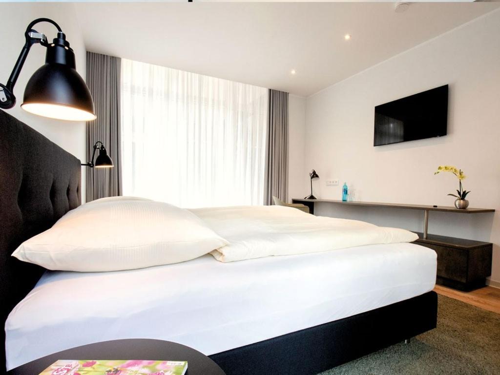 Postel nebo postele na pokoji v ubytování Hotel Busch